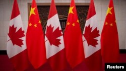 Picture of Canadian and Chinese flags taken prior to the meeting with Canada's Prime Minister Justin Trudeau and China's President Xi Jinping at the Diaoyutai State Guesthouse on December 5, 2017, in Beijing.