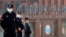FILE - Security personnel keep watch outside the Wuhan Institute of Virology in Wuhan, Hubei province, China, Feb. 3, 2021.