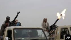 FILE - A Houthi rebel fighter fires a weapon into the air during a gathering aimed at mobilizing more fighters for the Houthi movement, in Sanaa, Yemen, Aug. 1, 2019.