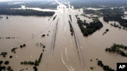 FILE - Interstate 69 is covered by floodwaters from Harvey, in Humble, Texas, Aug. 29, 2017. Just two weeks ago, President Donald Trump rolled back an order by his predecessor that would have made it easier for storm-ravaged communities to use federal emergency aid to rebuild structures so they can better withstand future disasters.
