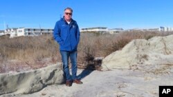 Mayor Patrick Rosenello stands next to a destroyed section of sand dune in North Wildwood, New Jersey, on Jan. 22, 2024. A winter storm punched a hole through what is left of the city's eroded dune system, leaving it more vulnerable than ever to flooding.