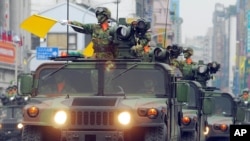FILE - A fleet of Taiwanese military vehicles loading U.S.-made TOW anti-tank missiles rehearse for National Day celebrations in Taipei, Taiwan, Oct. 8, 2007. 