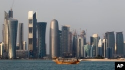 FILE - A traditional dhow floats in the Corniche Bay of Doha, Qatar, Jan. 6, 2011. Saudi media reported April 9, 2018, a proposal to dig a maritime canal along the kingdom's closed border with Qatar, turning the peninsula-nation into an island and further isolating it. 