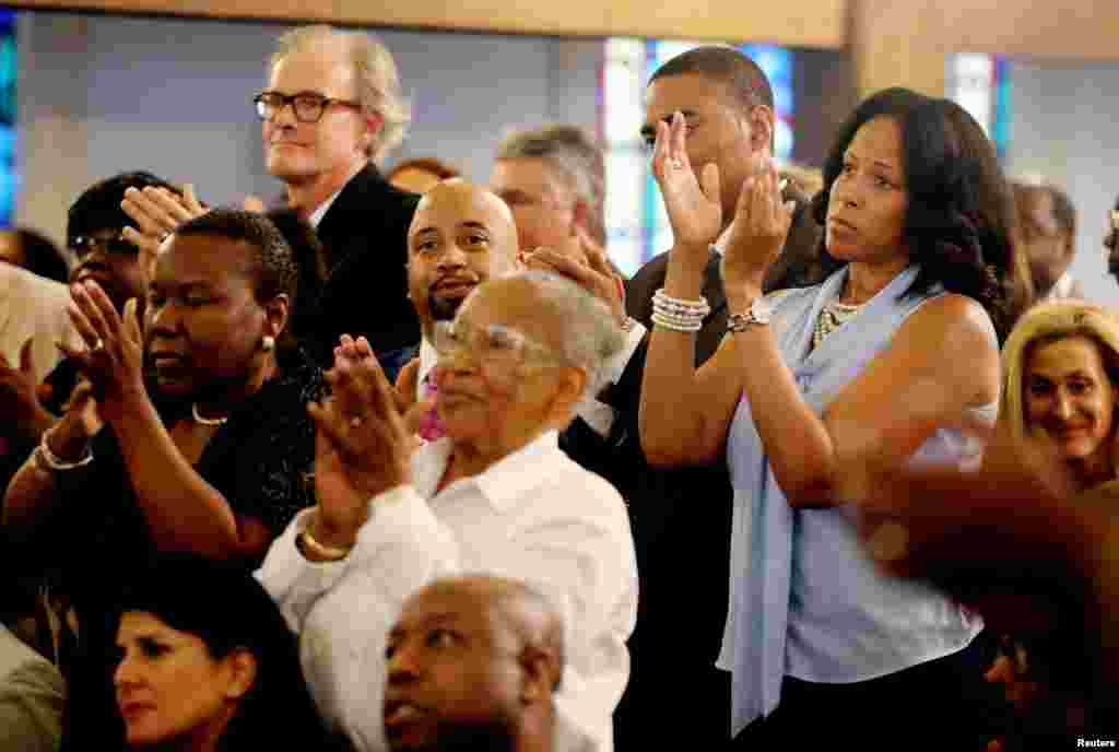 People applaud during a prayer vigil held at Morris Brown AME Church in Charleston, South Carolina, June 18, 2015. 