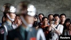 FILE - Honor guards perform in front of tourists from China at the Sun Yat-sen memorial in Taipei.