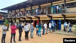 FILE - People wait in line for the opening of a polling office during the presidential election in Libreville, Gabon, Aug. 26, 2023. Soon after the election, longtime President Ali Bongo Ondimba was ousted by a coup.