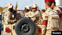 FILE - Military forces look on in North Sinai, Egypt, Dec. 1, 2017.