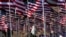 FILE - A young woman wearing a hijab stands amongst U.S. national flags erected by students and staff from Pepperdine University to honor the victims of the Sept. 11, 2001, attacks, at their campus in Malibu, California, Sept. 10, 2016.