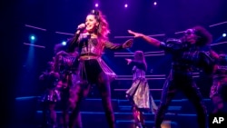 FILE PHOTO: A man in a protective mask walks past a closed theatre after it was announced that Broadway shows will cancel performances due to the coronavirus outbreak in New York, U.S., March 12, 2020. 