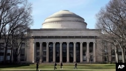 FILE - Students walk through the Massachusetts Institute of Technology campus in Cambridge, Mass., April 3, 2017. Harvard and MIT have filed a lawsuit challenging a guideline targeting international students whose coursework will be all online.