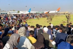 FILE - U.S. soldiers stand guard along the perimeter at the international airport in Kabul, Afghanistan, Aug. 16, 2021.