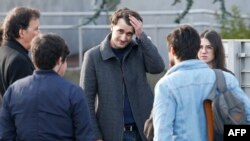 French journalist Loup Bureau (C) reacts as he stands with supporters and family members after addressing media representatives after his arrival at Roissy-Charles de Gaulle Airport on the outskirts of Paris, Sept. 17, 2017.