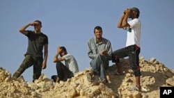 Libyan rebel fighters watch the border at the frontline of Al-Qawalish in the western mountains of Libya, after a battle with forces loyal to Libyan leader Moammar Gadhafi, July 14, 2011