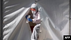 A medical staffer leaves the tent of a testing point for COVID-19 in central Moscow on May 2, 2020. 