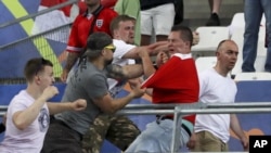 Clashes break out in the stands during the Euro 2016 Group B soccer match between England and Russia, at the Velodrome stadium in Marseille, France, Saturday, June 11, 2016. (AP Photo/Thanassis Stavrakis)