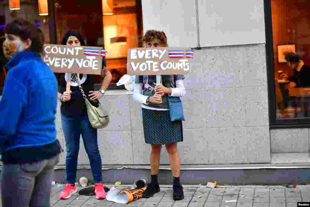 Activists hold signs saying "Every Vote Counts," after Democratic presidential nominee Joe Biden overtook President Donald Trump in the Pennsylvania general election vote count, in Philadelphia, Pennsylvania, Nov. 6, 2020.