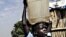 A Sudanese boy carries water home for his family.
