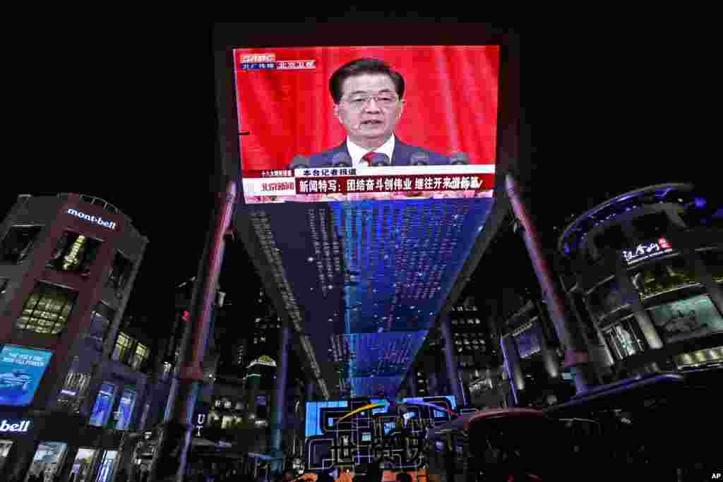 A huge screen shows a broadcast of Chinese President Hu Jintao speaking at the opening session of the 18th Communist Party Congress at the Great Hall of the People in Beijing, China, November 8, 2012. 