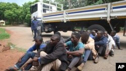 A policeman stands guard as some of the people arrested during demonstrations over the hike in fuel prices, make their court appearance at the magistrates courts in Harare, Zimbabwe, Wednesday, Jan,16, 2019. 