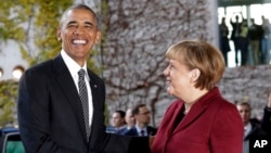 U.S. President Barack Obama, left, is welcomed by German Chancellor Angela Merkel prior to a meeting of the government heads of Germany, France, Italy, Spain and Britain in Berlin, Nov. 18, 2016.