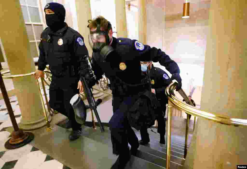 U.S. Capitol police officers take positions as protestors enter the Capitol building during a joint session of Congress to certify the 2020 election results on Capitol Hill in Washington, Jan. 6, 2021.