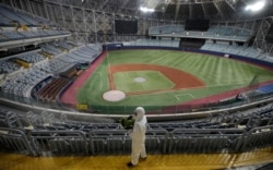 A worker wearing protective gears disinfects as a precaution against the new coronavirus at Gocheok Sky Dome in Seoul, South Korea, March 17, 2020.