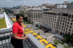 Mayor Muriel Bowser looks out over a Black Lives Matter sign that was painted on a street, during nationwide protests against the death in Minneapolis police custody of George Floyd, in Washington, D.C., June 5, 2020, in this handout photo.