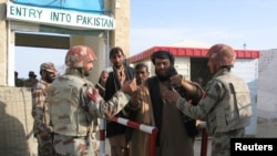 Pakistani soldiers check the identity of citizens returning from Afghanistan at the border town of Chaman, Pakistan, March 7, 2017. 
