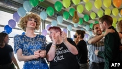 Campaigners react during the first projections following a nationwide referendum on same-sex marriage, in Swiss capital Bern, Sept. 26, 2021.