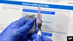 FILE - In this July 27, 2020, photo, a nurse prepares a syringe during a study of a possible COVID-19 vaccine in Binghamton, N.Y.