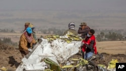 FILE - Rescuers work at the scene of an Ethiopian Airlines flight crash near Bishoftu, or Debre Zeit, south of Addis Ababa, Ethiopia, March 11, 2019.