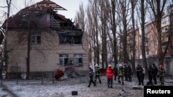 Rescuers and police officers examine parts of the drone at the site of a building destroyed by a Russian drone attack, as their attack on Ukraine continues, in Kyiv, Ukraine Dec. 14, 2022.