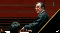 FILE - In this Oct. 19, 2011 file photo, world-renowned conductor Charles Dutoit, right, performs with the Philadelphia Orchestra. Four women have accused Dutoit of sexual misconduct that allegedly occurred on the sidelines of rehearsals or performances with some of America's great orchestras.