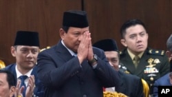 FILE - Indonesian Defense Minister and president-elect Prabowo Subianto salutes as he attends the annual lawmakers assembly to listen to President Joko Widodo's State of the Nation Address at the parliament building in Jakarta, Indonesia, Aug. 16, 2024. 
