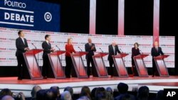 Democratic presidential candidates from left, entrepreneur Andrew Yang, Pete Buttigieg, Sen. Elizabeth Warren, former VP Joe Biden, Sen. Bernie Sanders, Sen. Amy Klobuchar, and businessman Tom Steyer in Los Angeles, Dec. 19, 2019.