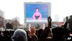 FILE - North Koreans watch a news broadcast on a video screen outside Pyongyang Railway Station in Pyongyang, North Korea, Jan. 6, 2016.