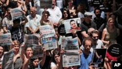 FILE - Protesters demonstrate against the jailing of two journalists and an academic, outside the offices of Ozgur Gundem, a pro-Kurdish publication, in Istanbul, June 21, 2016. 