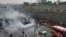 FILE - Riot police try to disperse protesters as they rally on a highway against increased fuel prices, in Tehran, Iran, Nov. 16, 2019.