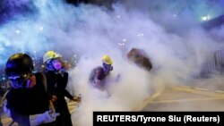 China, Hong Kong, Anti-extradition bill protesters walk among tear gas as they attend a march in Hong Kong