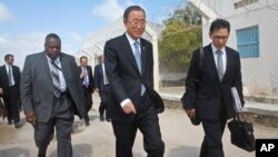 U.N. Secretary-General Ban Ki-moon, center, walks inside the heavily-protected airport complex during a visit to Mogadishu, Somalia, Oct. 29, 2014.