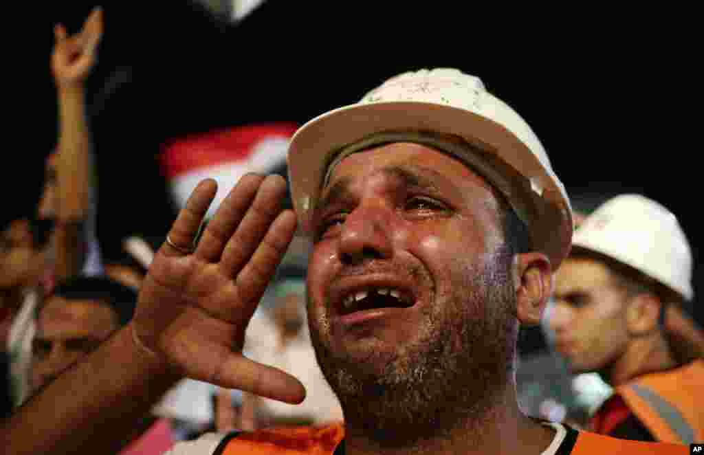 An Egyptian child attends prayers with his father at a protest near Cairo University in Giza, Egypt, August 1, 2013.&nbsp;