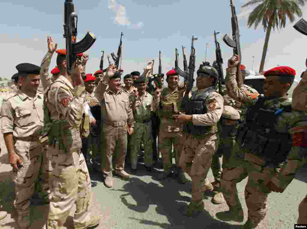 Sunni Islamist militants gained more ground in Iraq overnight, moving into two towns in the eastern province of Diyala, while U.S. President Barack Obama considered military strikes to halt their advance towards Baghdad. Seen here are members of Iraqi security forces chanting slogans, Baghdad, June 13, 2014.