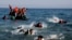 FILE - Migrants whose boat stalled at sea while crossing from Turkey to Greece swim to approach the shore of the island of Lesbos, Greece, Sept. 20, 2015. 