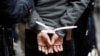A subject stands in plastic handcuffs after being arrested by New York City Police in this November 17, 2011, file photo.
