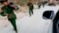 Myanmar army soldiers walk along a road near Laukkai, February 17, 2015.