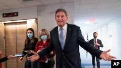 FILE - Sen. Joe Manchin, D-W.Va., leaves his office moments after speaking with President Joe Biden about his long-stalled domestic agenda, at the Capitol in Washington, Dec. 13, 2021. 