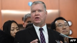 U.S. special representative on North Korea Stephen Biegun, center, speaks to reporters as his South Korean counterpart Lee Do-hoon, right, looks on after their "working group" meeting handling North Korean issues at the Foreign Ministry in Seoul on Dec.