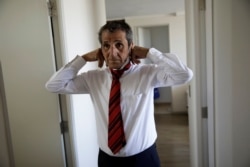Gino Rojas gets dressed at his house in Santiago, Chile, Dec. 9, 2019.