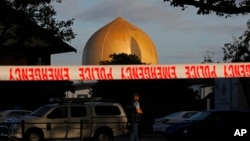 FILE - A police officer stands guard in front of the Al Noor Mosque in Christchurch, New Zealand, March 17, 2019, where one of the two mass shootings occurred.