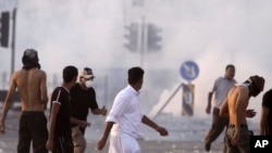 Riot police fire tear gas in Sitra, Bahrain, September 16, 2011.